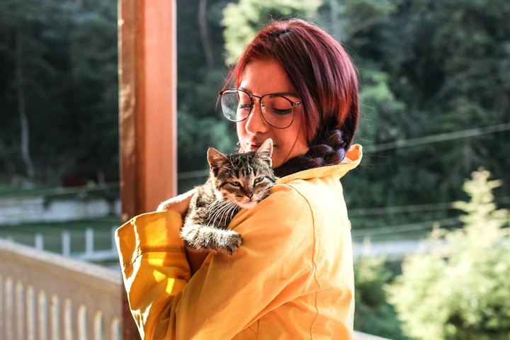 Woman carrying her cat outdoors