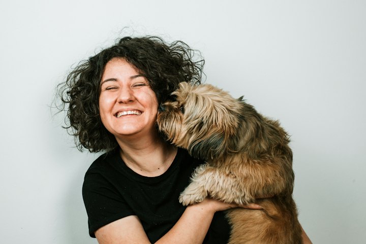Happy dog giving its owner a kiss